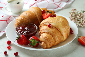 Concept of tasty breakfast with croissants on white textured table
