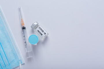 Close up a vial of covid-19 vaccine in hand of a scientist or doctor
