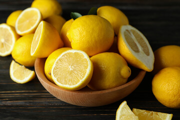 Ripe lemons on wooden background, close up