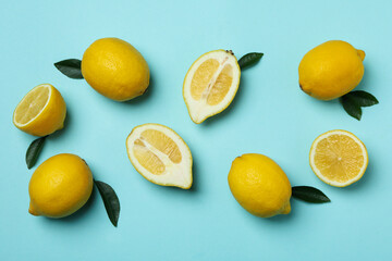 Ripe lemons on blue background, top view