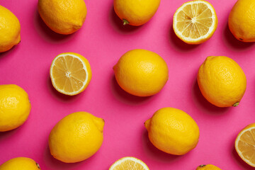 Fototapeta na wymiar Ripe lemons on pink background, top view