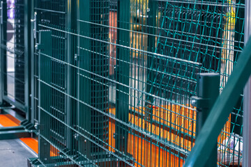 Green steel bar fence. Modern fencing systems