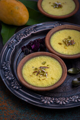 mango-flavored Phirni served in earthen plate 