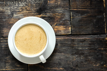 Coffee cup and coffee beans. Copy space. Espresso or Americano in a cup. Wooden background.
