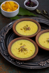 mango-flavored Phirni served in earthen plate 