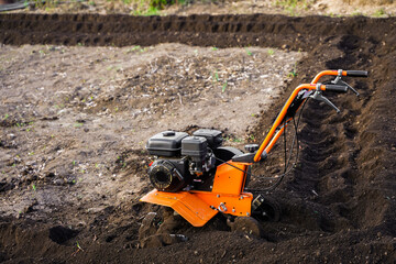 Gasoline cultivator, soil tillage, loosening. Plow, tractor gardening agriculture.