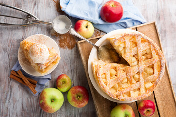 Homemade summer or autumn apple pie on rustic wooden background.