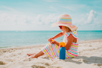 little girl with suncream at beach vacation, sun protection - 434514147