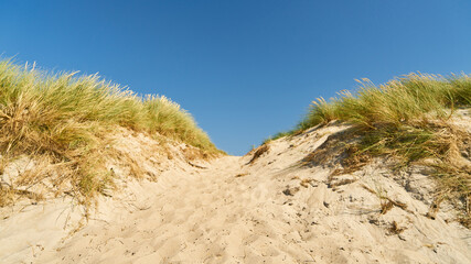 Landscape with dunes and sand and blue sky
