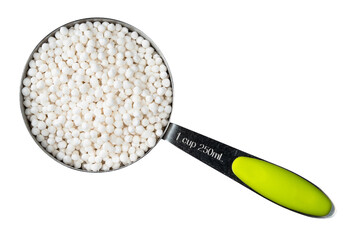 sabudana (tapioca sago) in measuring cup cutout
