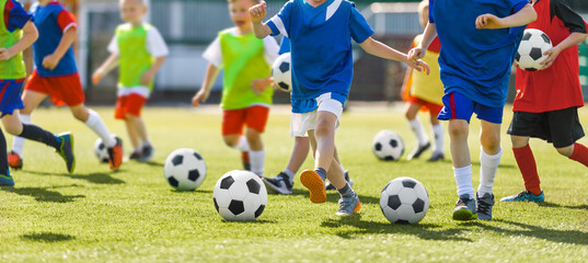 Soccer School Training. Children Running Soccer Football Balls on Practice Grass Venue. Children...