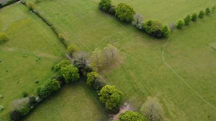 An aerial view looking from directly above of green fields and hedges