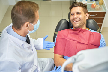 Joyous gentleman smiling at a dentist appointment