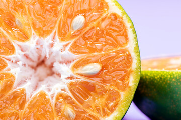 Close-up ,The Orange fruit  on purple backdrop.The fruit have many vitamin C.