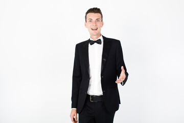 Man toastmaster points on something. Young man master performing on the stage. Man on white background with copy space