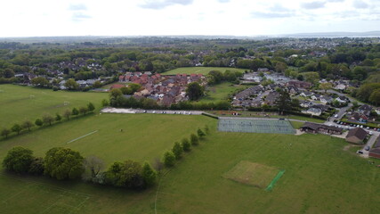 Aerial view of playing fields, trees and new housing development