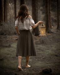 young woman with lantern in the dark forest  © Martin Moutayrek ©