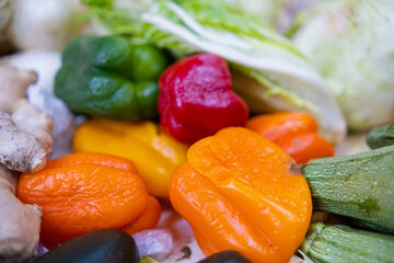 Close-up of colorful bell peppers, lettuce, zucchini, and ginger roots