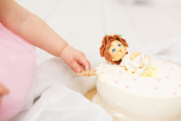 Delicious birthday cake. Beautiful cake decorated by tender sweet baby girl in a flower. Cake smash