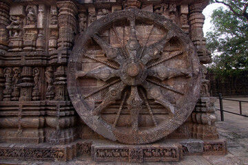 Ancient sandstone carved wheel on Konark sun temple in Odisha, India
