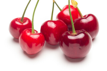 Small red cherries on a white background