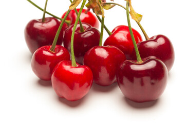Small red cherries on a white background