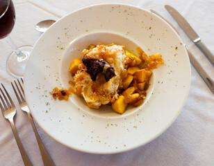 Huevos rotos con morcilla, scrambled eggs with blood sausage, potatoes and caramelized onions