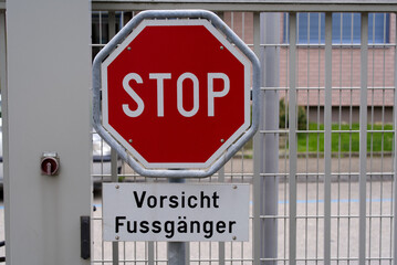Stop traffic sign with text Vorsicht Fussgänger (German, translation is watch out for pedestrians). Photo taken May 19th, 2021, Zurich, Switzerland.