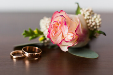 Wedding boutonniere from rose flower and rings