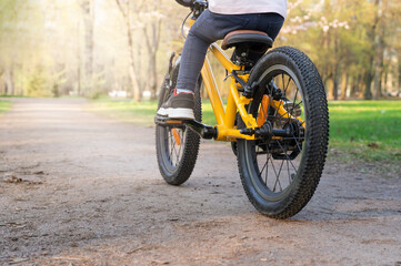 Photo of girl riding yellow bicycle.