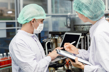 Quality control and food safety team inspection the product standard in the food and drink factory production line.