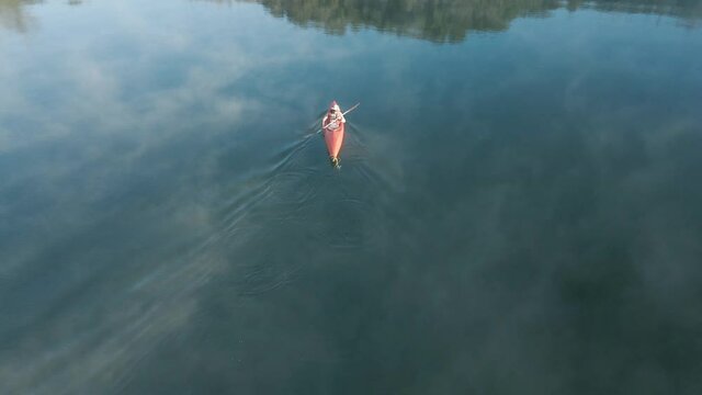 4K Drone footage of young  Indian kayaking in a misty lake in Kotagiri, Nilgiris, Chennai Tamil Nadu, India 60FPS for slow motion