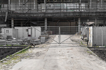 Restoration and restoration of an old building. Metal scaffolding around a large and tall building at a construction site.