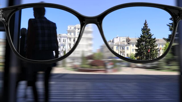 sharpness with glasses walking around the city