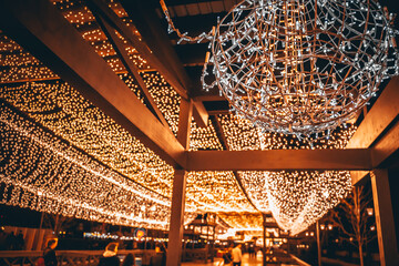 Garlands in the park, the ceiling of glowing lights