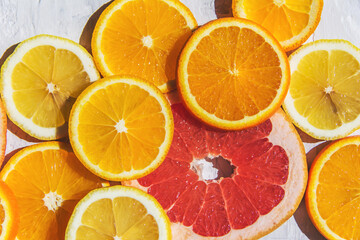 Fototapeta na wymiar Citrus fruits. Orange, lemon, grapefruit, on a trendy stone background Top view, flat lay