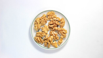 Walnut kernels in a saucer on the table.