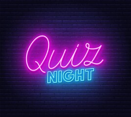 Quiz Night neon sign on brick wall background.
