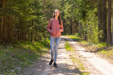 Lonely one girl walk in the road forest summer spring background, Relax time on holiday concept travel.