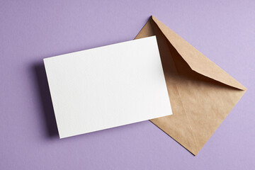 Minimal stationary card mockup with envelope on lavender color paper background