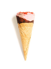 
Ice cream cone close up. Pink ice cream scoop in a waffle cone on an isolated white background. Strawberry or raspberry flavor sweet dessert decorated with chocolate and colorful sprinkles, close up