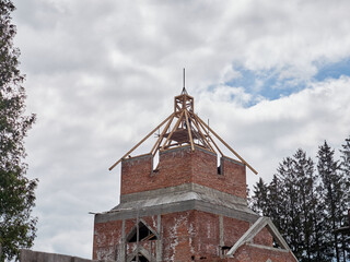 Workers are building a spire for the future church.