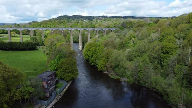 Aerial view Pontcysyllte aqueduct and River Dee canal narrow boat bride in Chirk Welsh valley countryside high to low