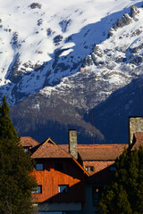 Fototapeta na wymiar part of the llao llao hotel with snowy mountains in the background