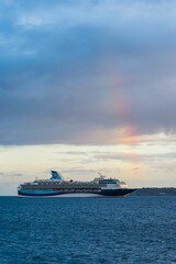 Fototapeta na wymiar Sunset and Rainbow over Cruise ferries in Torquay, Devon, England, Europe