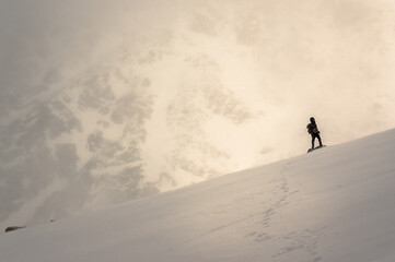 Monkh Saridag mountain, Mondy, Buryatia, Russia - 04 25 2021: a man walking in snowy mountains