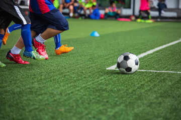 Children playing soccer ball tactics on grass field with for training
