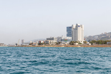 View of the embankment and the Downtown from the water area of the Haifa Bay, in the Mediterranean Sea, near the port of Haifa in Israel