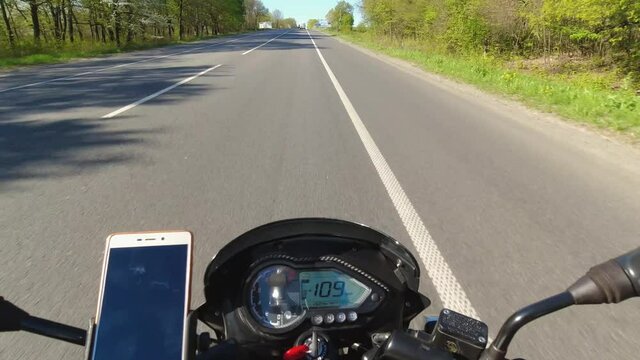 Motorcycle riding on the asphalt road, slow motion, moto traveling at the summer, first person point of view, pov
