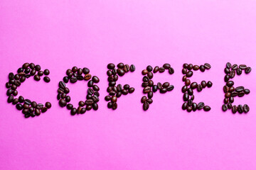 Food and Beverages Concepts. Word Made Of Variety of Freshly Roasted Coffee Beans Placed on Pink Background.